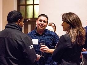 Three people talking in at a networking event