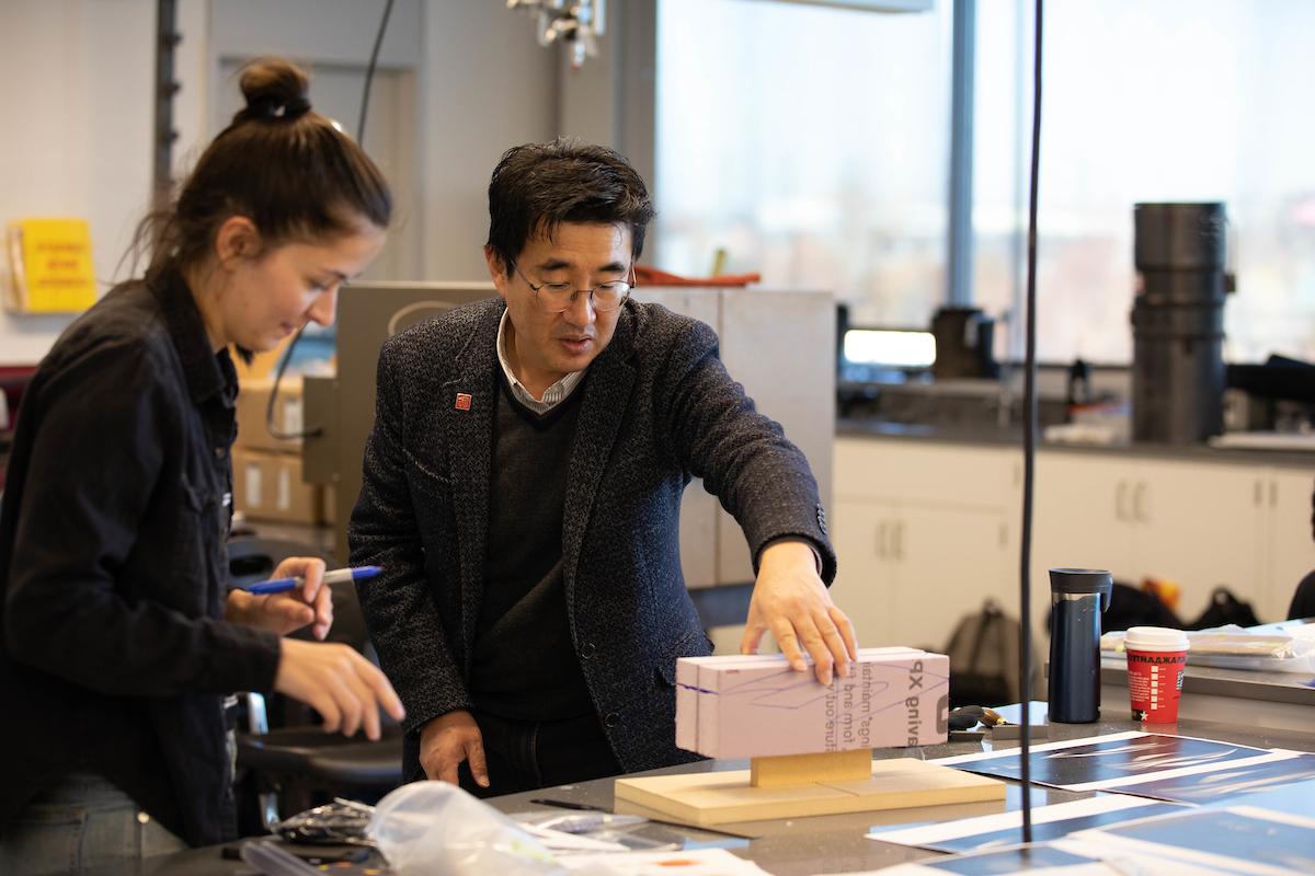 Instructor working on a foam model with a student