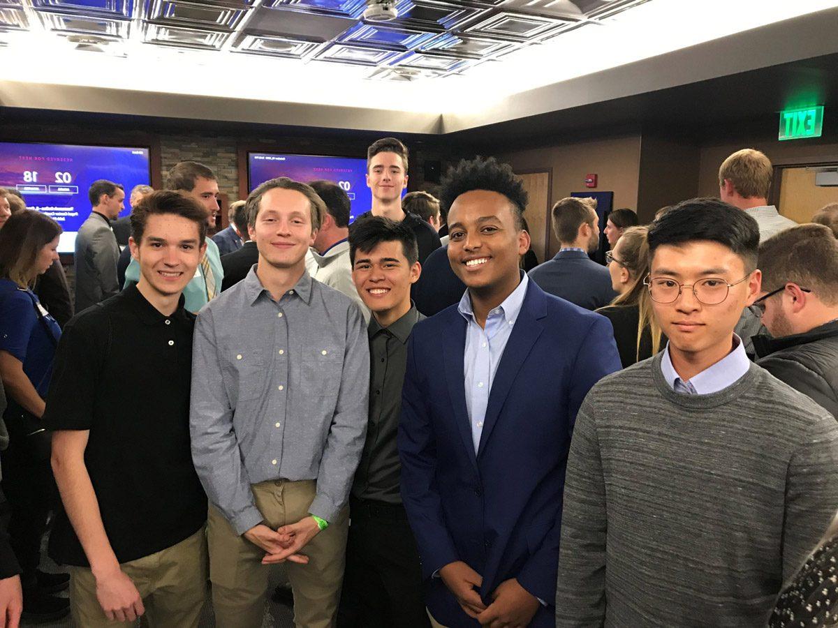 Group of male students at an indoors networking event