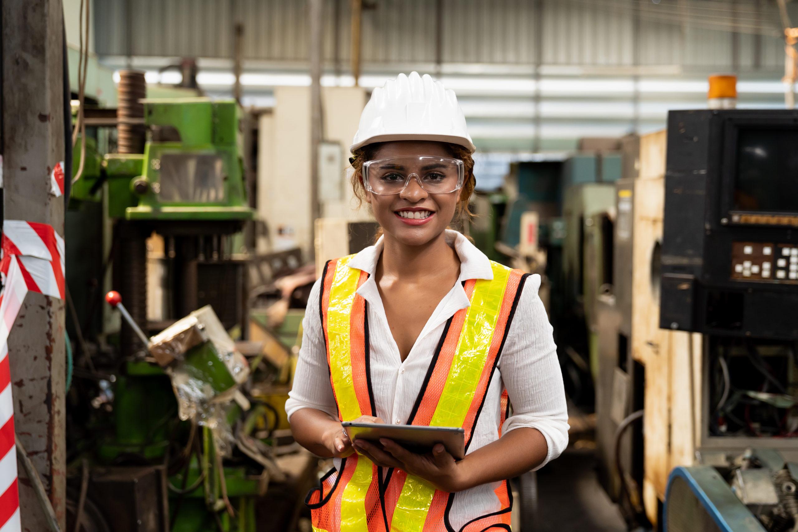 Woman in hardhat in manufacturing facility