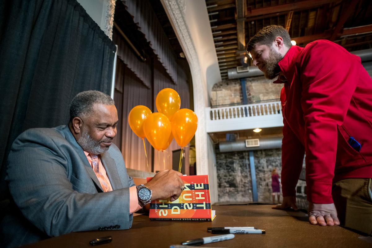 Anthony Ray Hinton signing his book with a student