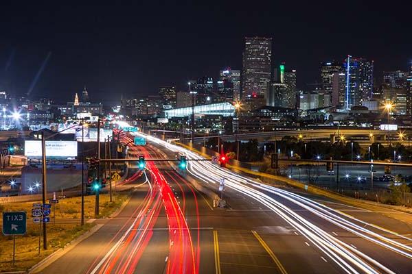 Downtown Denver at night during rush-hour traffic.